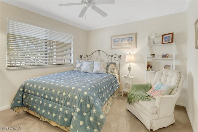 carpeted bedroom with baseboards and a ceiling fan