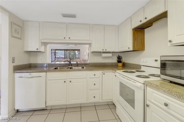 kitchen with white appliances, light tile patterned floors, visible vents, white cabinets, and a sink