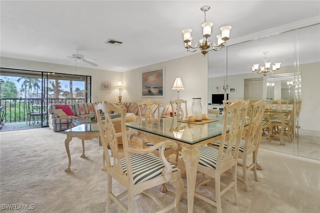 dining space featuring ceiling fan with notable chandelier, carpet flooring, and visible vents