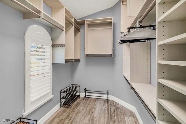 1015 Goldenrod Ave, Marco Island, FL 34145 - walk in closet featuring vaulted ceiling and wood finished floors