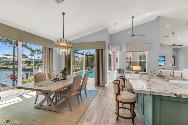 1015 Goldenrod Ave, Marco Island, FL 34145 - dining space featuring light wood-style floors, plenty of natural light, and ceiling fan with notable chandelier