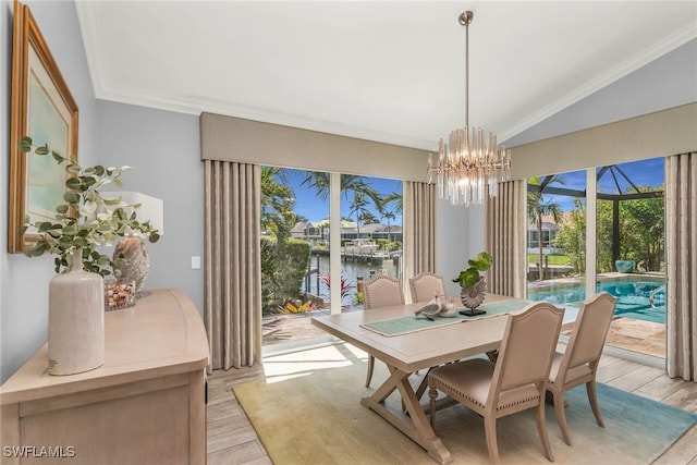 1015 Goldenrod Ave, Marco Island, FL 34145 - dining space featuring crown molding, lofted ceiling, light wood-style flooring, and a healthy amount of sunlight
