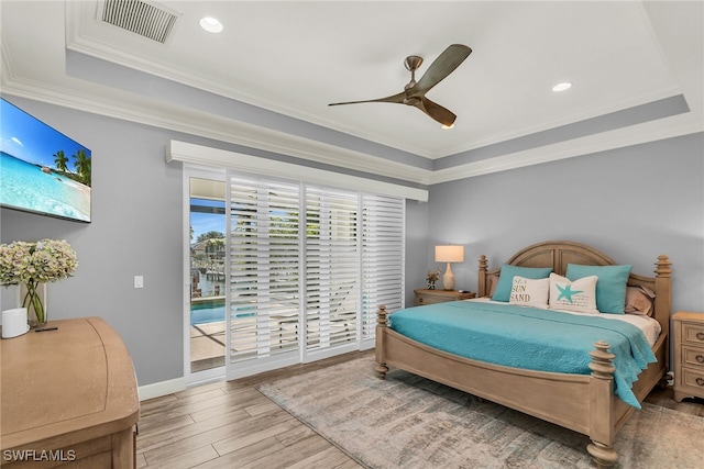 1015 Goldenrod Ave, Marco Island, FL 34145 - bedroom featuring visible vents, a raised ceiling, wood finished floors, access to outside, and crown molding