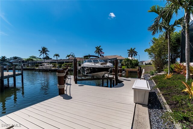 1015 Goldenrod Ave, Marco Island, FL 34145 - view of dock featuring a water view and boat lift