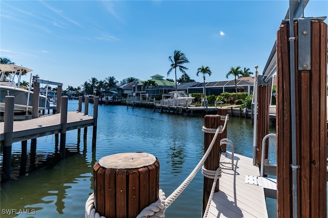 1015 Goldenrod Ave, Marco Island, FL 34145 - dock area with a water view and boat lift