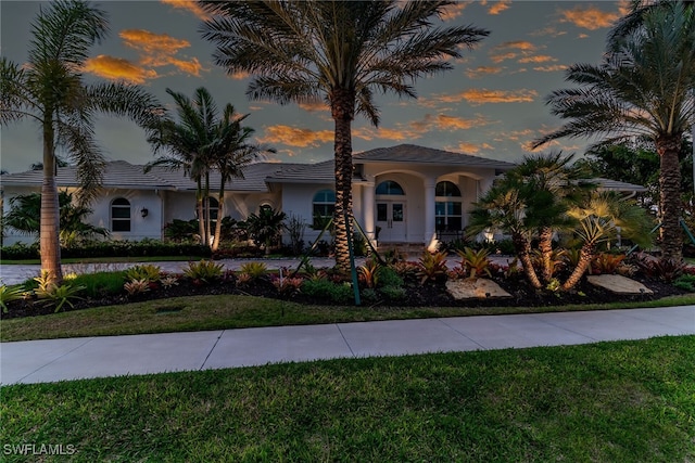 view of front of property featuring a front lawn and stucco siding