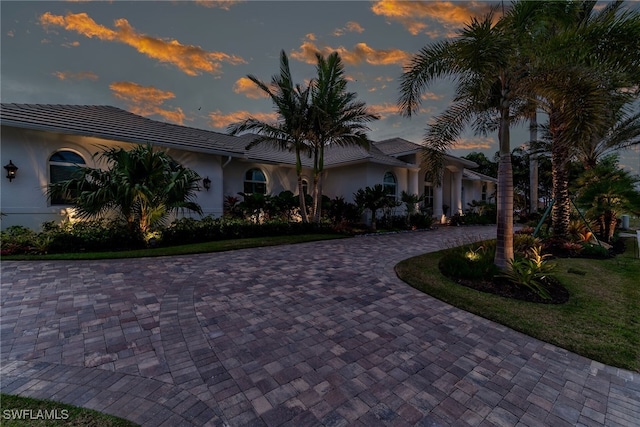 1015 Goldenrod Ave, Marco Island, FL 34145 - view of front of property featuring a yard, curved driveway, and stucco siding
