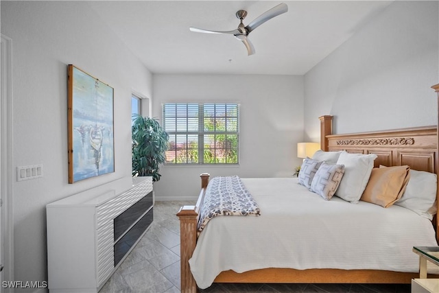 bedroom with ceiling fan and baseboards