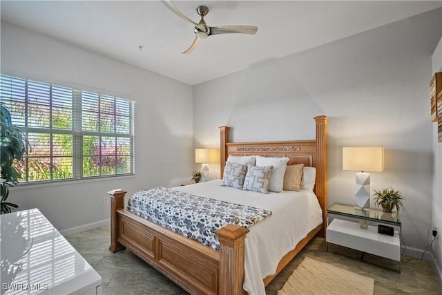 bedroom featuring a ceiling fan and baseboards