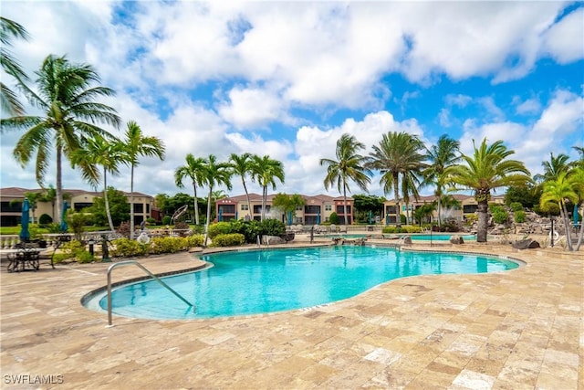 pool featuring a patio area and a residential view