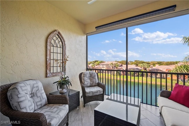 sunroom / solarium featuring a water view