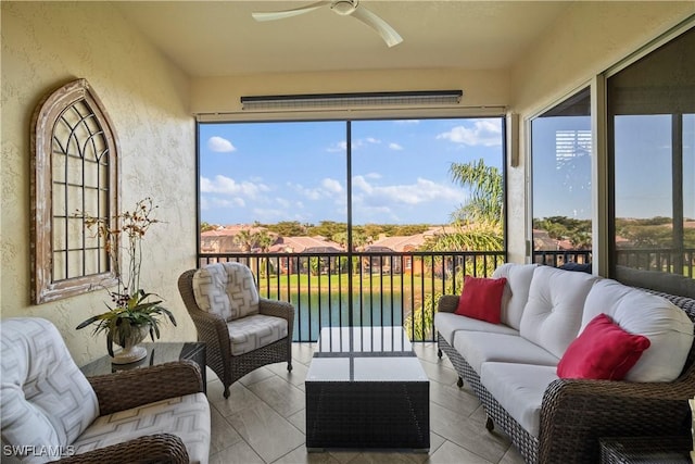 sunroom / solarium featuring a ceiling fan