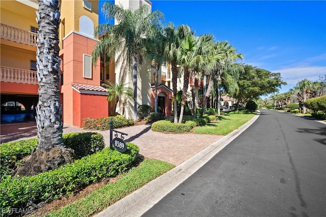 view of street featuring a residential view and curbs