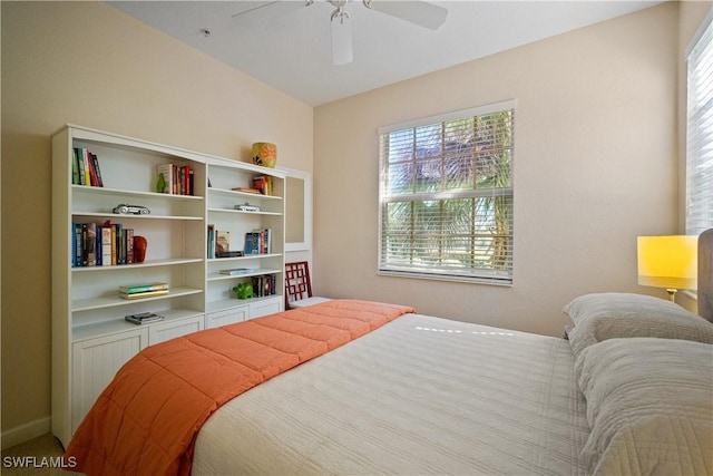 bedroom featuring a ceiling fan and multiple windows