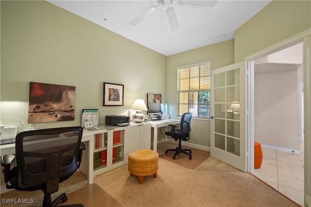 home office with carpet floors, baseboards, a ceiling fan, and tile patterned floors