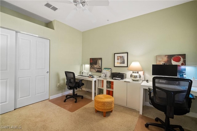 carpeted home office featuring baseboards, visible vents, and a ceiling fan