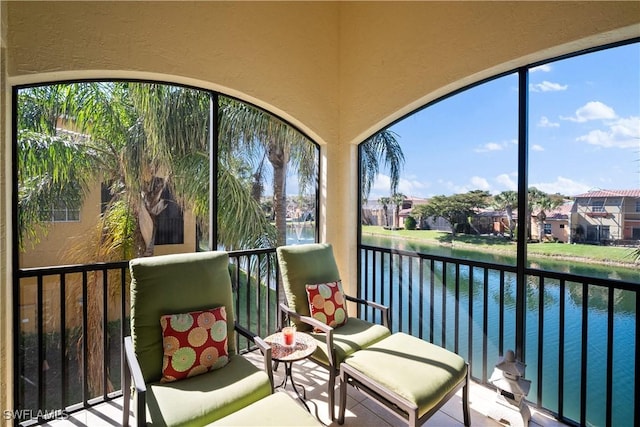 balcony with a residential view and a water view