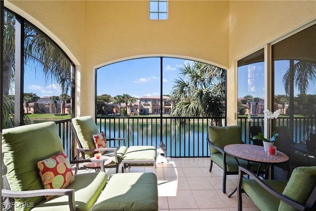 sunroom / solarium featuring a water view and a wealth of natural light