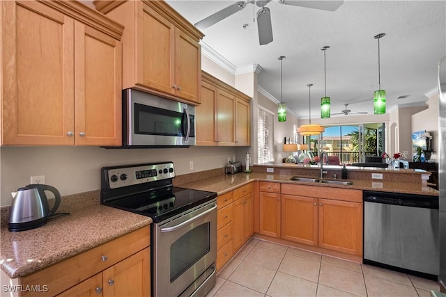 kitchen with stainless steel appliances, ornamental molding, a peninsula, and a sink