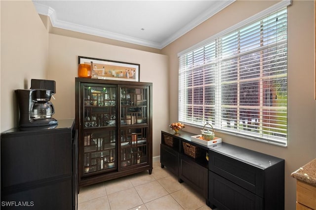 bar with light tile patterned floors and crown molding