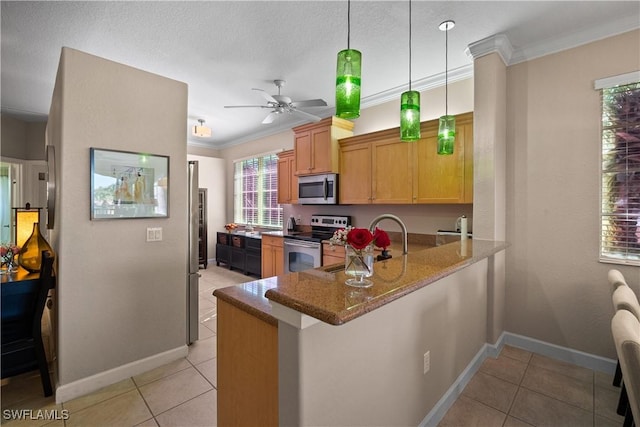 kitchen with light tile patterned floors, stainless steel appliances, light stone counters, and crown molding