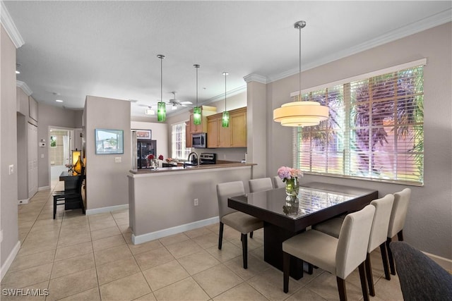 dining area with baseboards, ornamental molding, a ceiling fan, and light tile patterned flooring