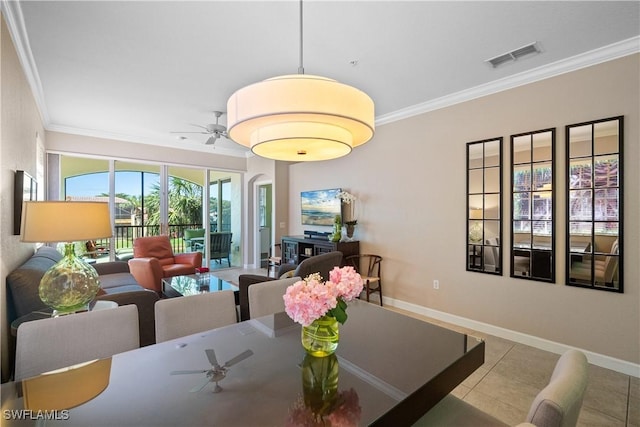 tiled dining area with ornamental molding, visible vents, and baseboards