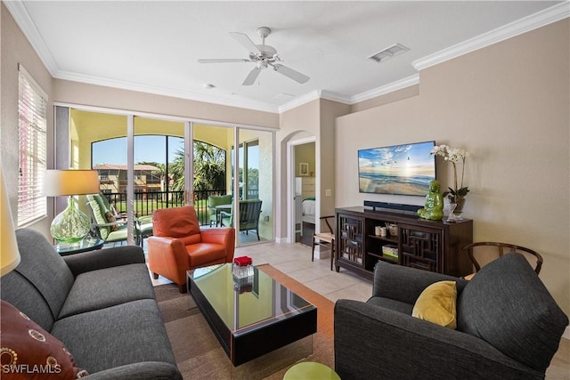 living area featuring plenty of natural light, visible vents, ornamental molding, and tile patterned floors