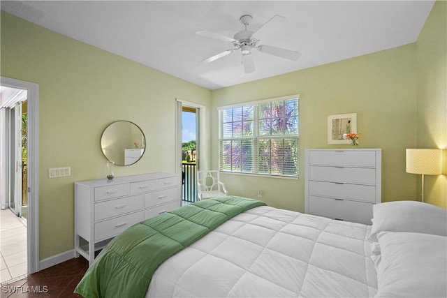 bedroom featuring a ceiling fan, tile patterned flooring, and baseboards