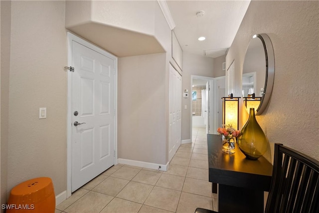 foyer entrance featuring light tile patterned floors and baseboards