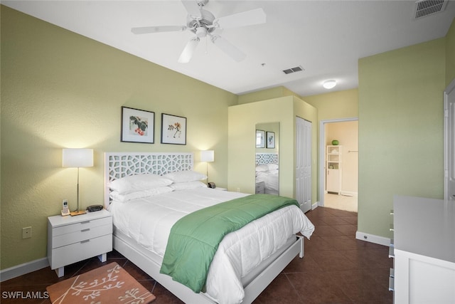bedroom featuring baseboards, visible vents, and dark tile patterned flooring