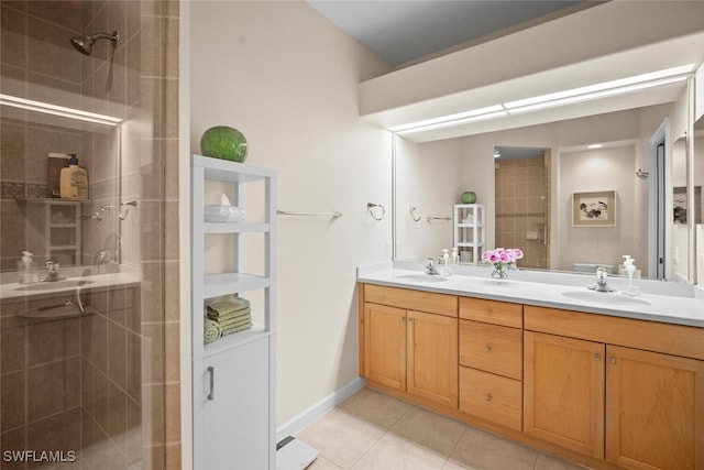 full bath with a shower stall, tile patterned flooring, a sink, and double vanity