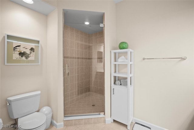 full bath with a shower stall, toilet, tile patterned floors, and baseboards