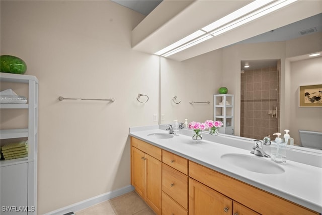 bathroom with tile patterned flooring, visible vents, a sink, and double vanity