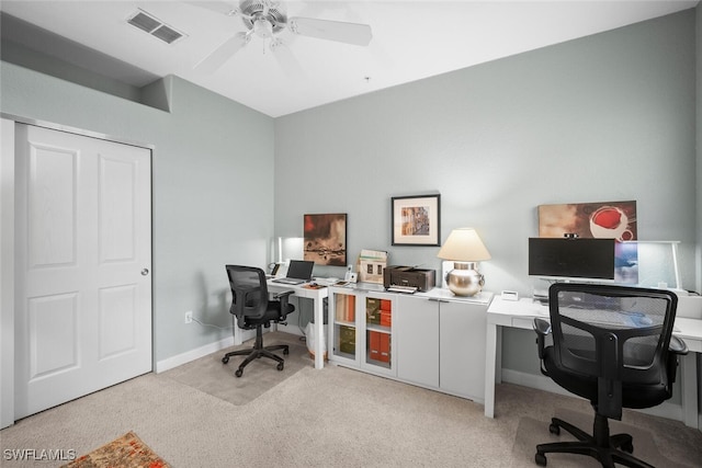 carpeted office space with baseboards, a ceiling fan, and visible vents