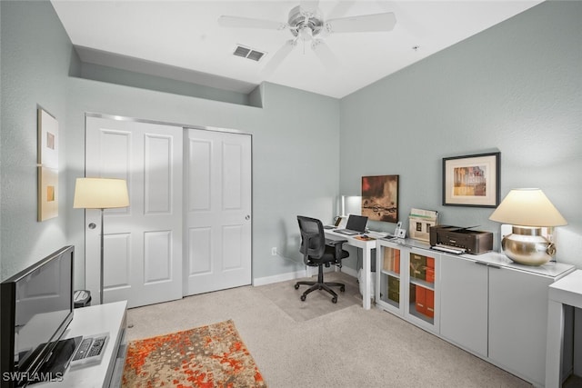 office featuring baseboards, a ceiling fan, carpet flooring, and visible vents