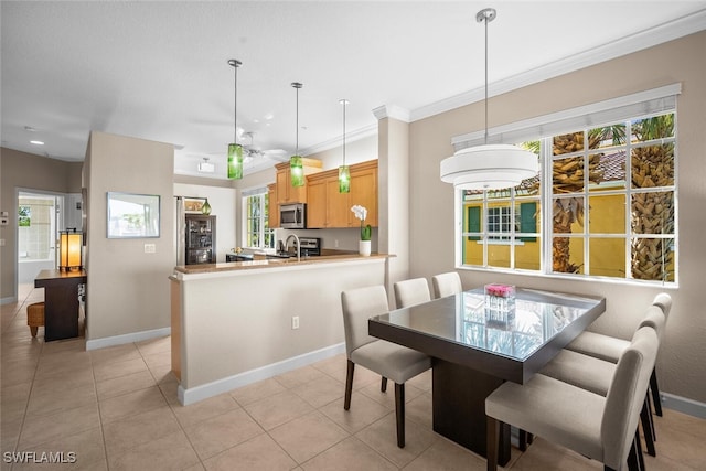 dining space featuring plenty of natural light, baseboards, and light tile patterned floors