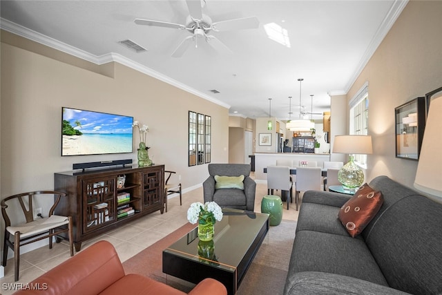 living room featuring ceiling fan, crown molding, visible vents, and plenty of natural light