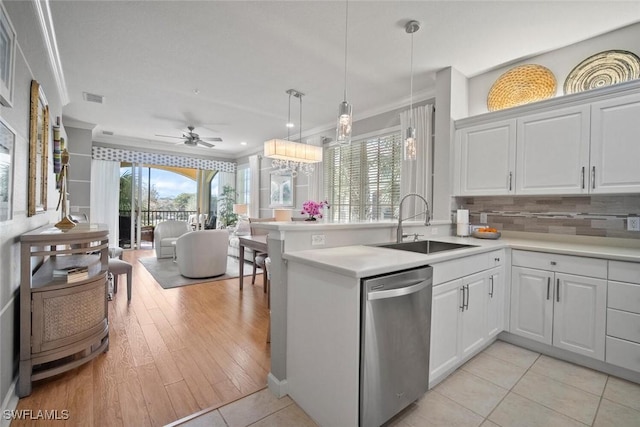 kitchen featuring visible vents, dishwasher, open floor plan, crown molding, and a sink