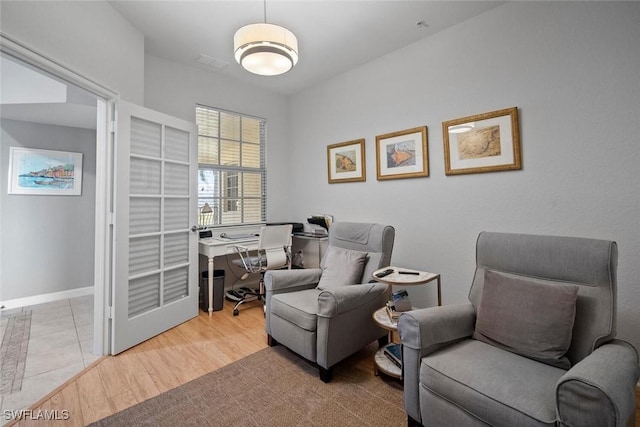 sitting room with wood finished floors and baseboards