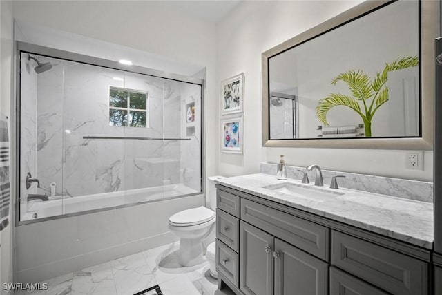 bathroom with marble finish floor, vanity, toilet, and bath / shower combo with glass door