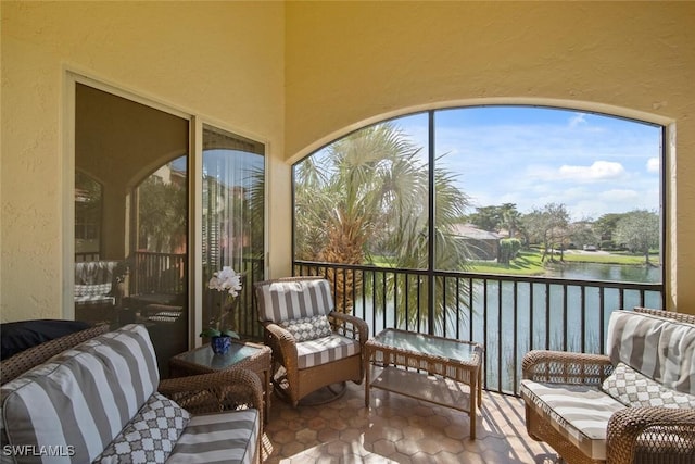 sunroom / solarium featuring a water view