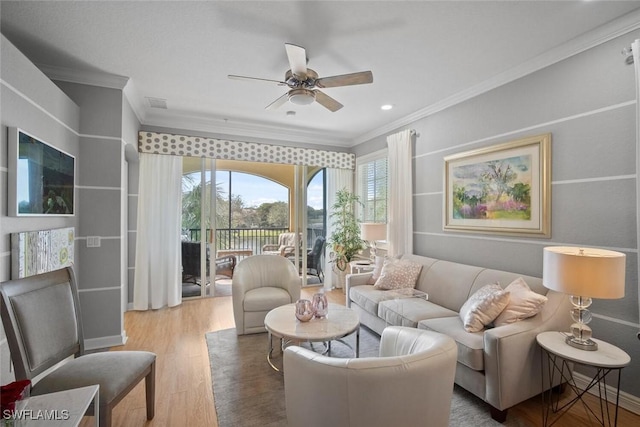 living area featuring visible vents, ornamental molding, wood finished floors, and a ceiling fan