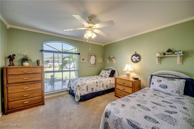 carpeted bedroom featuring crown molding and ceiling fan