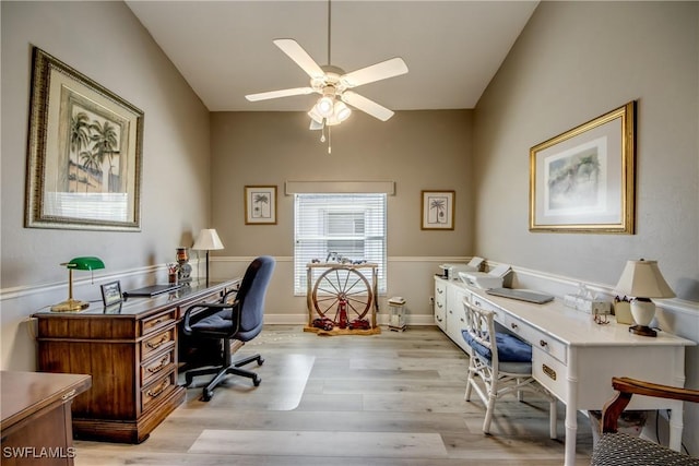 home office with light wood-style floors, lofted ceiling, ceiling fan, and baseboards