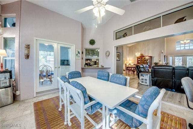 dining area with high vaulted ceiling, french doors, and plenty of natural light