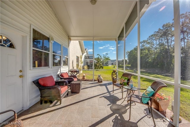 sunroom featuring lofted ceiling