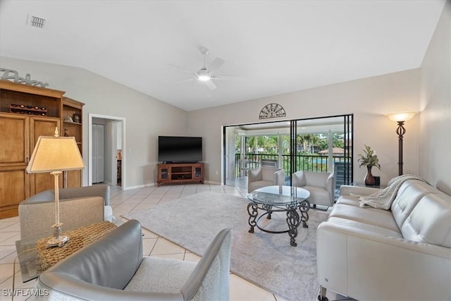 living room with light tile patterned floors, lofted ceiling, visible vents, ceiling fan, and baseboards