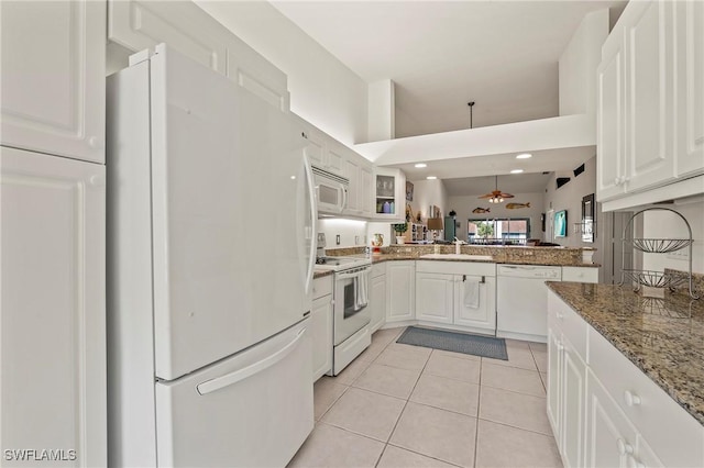 kitchen featuring white appliances, light tile patterned floors, ceiling fan, white cabinetry, and a sink