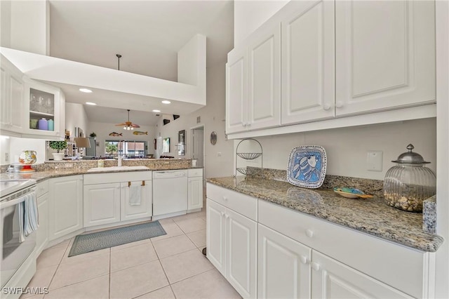 kitchen featuring white appliances, white cabinets, and ceiling fan